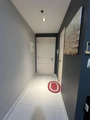 a hallway with a white door and a red rug at Cozy Room with Citiview at Greenbelt Makati in Manila