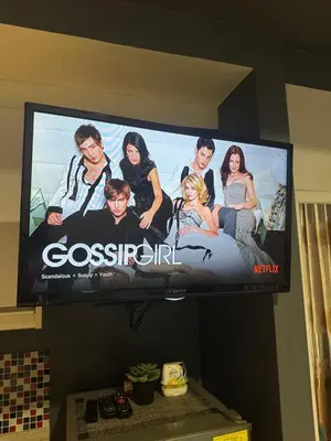 a flat screen tv hanging on a wall at Cozy Room with Citiview at Greenbelt Makati in Manila