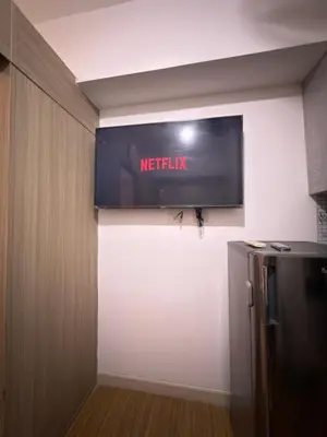 a television on the wall of a kitchen at Netflix and Chill at Ephra Homestay - Grace Residences Tower 4 in Manila