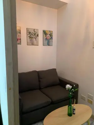 a living room with a couch and a table at Netflix & Chill at Pablo's Homestay-Grace Residences Tower 4 in Manila