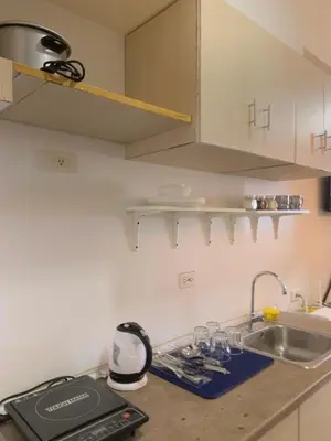 a kitchen with a sink and a counter top at Netflix & Chill at Pablo's Homestay-Grace Residences Tower 4 in Manila