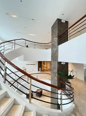 a spiral staircase in a building with a lobby at 2BR Solana Suite near MOA PICC NAIA in Manila