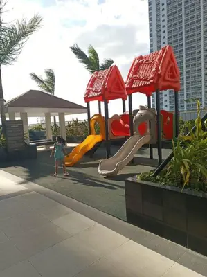 a little girl is playing on a playground at 2BR Solana Suite near MOA PICC NAIA in Manila