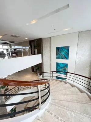 a lobby with a spiral staircase in a building at 2BR Solana Suite near MOA PICC NAIA in Manila