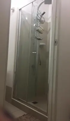 a shower stall with a glass door with a shower at 20th flr SMDC Lights Residence Mandaluyong City Philippines in Manila