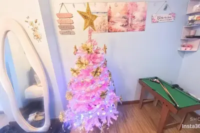 a christmas tree in a room with a mirror at Azure staycationbyGetwellwander in Manila