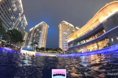two tall buildings in a city at night at Azure staycationbyGetwellwander in Manila