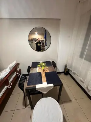 a table and chairs in a room with a mirror at Resort-Style 2BR Condo at Alea DMCI Family Staycation in Manila
