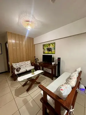 a living room with a couch and a table at Resort-Style 2BR Condo at Alea DMCI Family Staycation in Manila