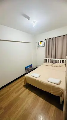 a bedroom with a bed with two white pillows on it at Resort-Style 2BR Condo at Alea DMCI Family Staycation in Manila