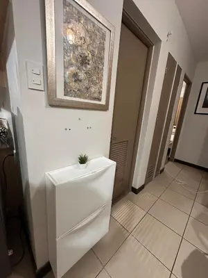 a bathroom with a toilet with a painting on the wall at Resort-Style 2BR Condo at Alea DMCI Family Staycation in Manila