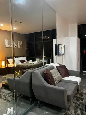 a living room with a couch and a bed at Premium Suite with Balcony at The Gramercy Makati Manila in Manila
