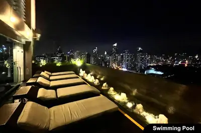 a balcony with a view of a city at night at Premium Suite with Balcony at The Gramercy Makati Manila in Manila