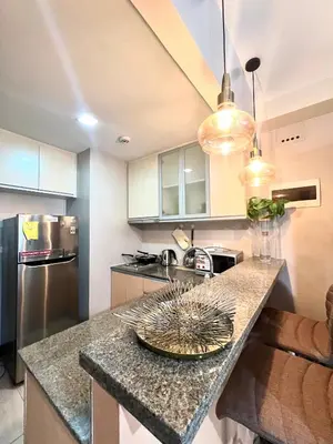 a kitchen with a counter with a plate on it at Deluxe Studio with Balcony at Greenbelt Makati Manila in Manila