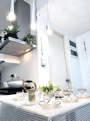 a table with dishes on it in a kitchen at DT SUITES AND RESORTS at Azure Paranaque in Manila