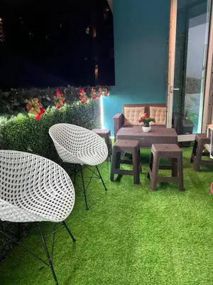 a patio with a table and two chairs and a table and bench at DT SUITES AND RESORTS at Azure Paranaque in Manila