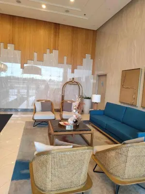 a living room with a blue couch and chairs at Amelia's Crib at The Verdin in General Trias