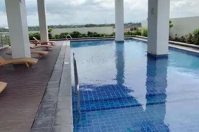 a swimming pool with lounge chairs on the deck of a hotel at Amelia's Crib at The Verdin in General Trias