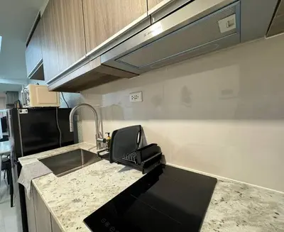 a kitchen with a sink and aaucet at Park Mckinley West 1BR Balcony near BGC Makati Airport in Manila