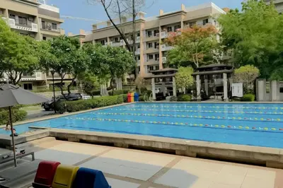 a large swimming pool in front of a building at 2 Bedroom with Resort Facilities near BGC and Makati in Manila