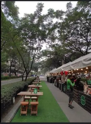 a group of tables and benches on a sidewalk at 2 Bedroom with Resort Facilities near BGC and Makati in Manila