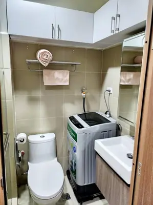 a small bathroom with a toilet and a sink at Mocha Flat at Shore 3 Tower 4 in Manila