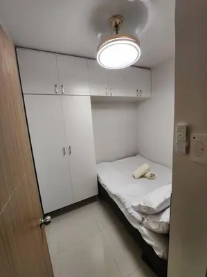 a small room with a bed and a light at Mocha Flat at Shore 3 Tower 4 in Manila