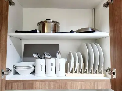 a shelf with plates and utensils in a kitchen at Mocha Flat at Shore 3 Tower 4 in Manila