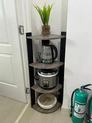 a shelf with a coffee maker on top of a toilet at DT Suites and Resorts at Azure Paranaque in Manila