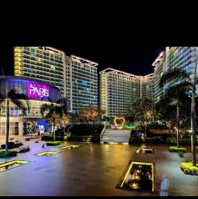 a night view of a resort with tall buildings at DT Suites and Resorts at Azure Paranaque in Manila
