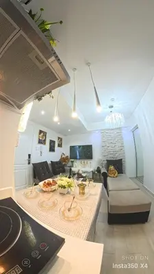 a living room with a couch and a table at DT Suites and Resorts at Azure Paranaque in Manila