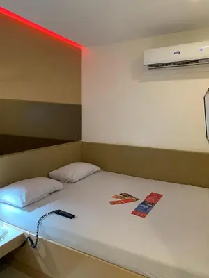 a room with a bed with a remote control on it at Hotel Sogo Bacoor in Bacoor