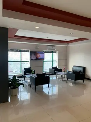 a waiting room with couches and chairs in a building at Hotel Sogo Bacoor in Bacoor