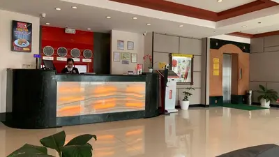 a lobby of a restaurant with a reception counter at Hotel Sogo Bacoor in Bacoor