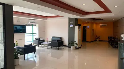 a lobby of a hospital with chairs and tables at Hotel Sogo Bacoor in Bacoor