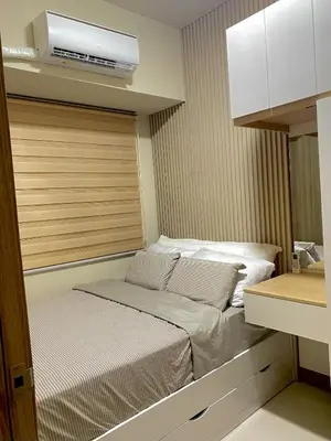 a small bedroom with a bed in a room at Coast Residences condo near MOA, StarCity and PICC in Manila