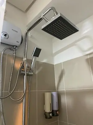 a bathroom with a shower with a light on the ceiling at Coast Residences condo near MOA, StarCity and PICC in Manila
