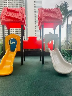 a play area with a slide and a slideintend at Coast Residences condo near MOA, StarCity and PICC in Manila