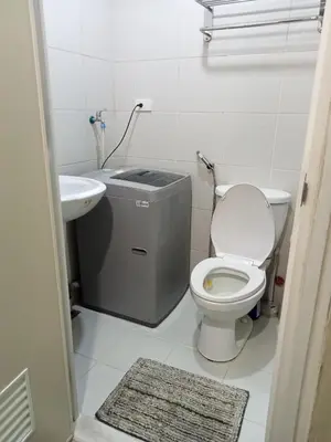 a small bathroom with a toilet and a sink at Jazz staycation in Manila
