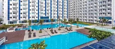 a large apartment building with a large swimming pool at Jazz staycation in Manila