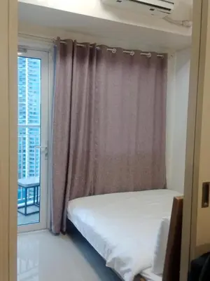 a bedroom with a bed and a window at Jazz staycation in Manila