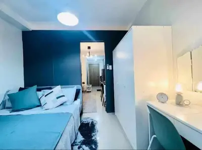 a room with a bed and a blue wall at 1 BR Apartment near SM Mall of Asia, Airport, Manila in Manila