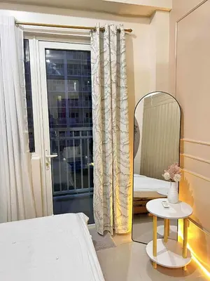a bedroom with a mirror and a bed and a table at Espacio Tres in Manila