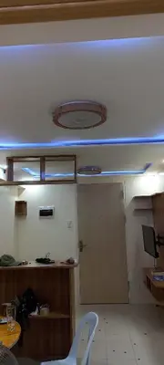 an office room with a door and a table and chairs at Two bed room unit with parking space in Manila