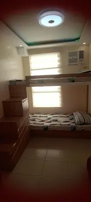 a room with a window and a bed in it at Two bed room unit with parking space in Manila