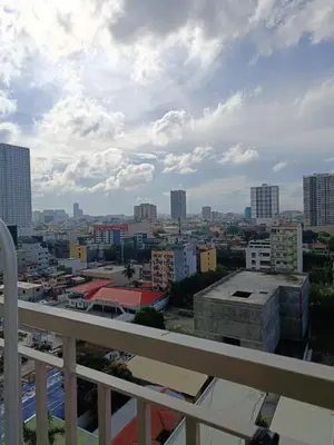 a view of a city from a balcony at Coast Residences-Ronnzel staycation in Manila