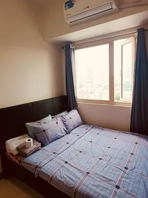 a bed in a room with a large window at Coast Residences-Ronnzel staycation in Manila