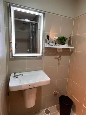 a bathroom with a sink and a mirror at BALAY MULANO at FAME RESIDENCES MANDALUYONG CITY l with balcony pool view l 200mbps wifi in Manila