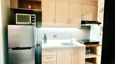 a kitchen with a refrigerator and a sink at 9D Standard Room staycation in Manila