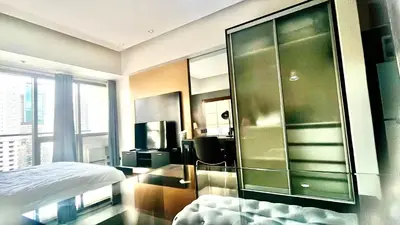 a bedroom with a large glass wall at 9D Standard Room staycation in Manila